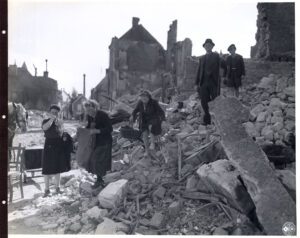 French family try to salvage some belongings from the ruins