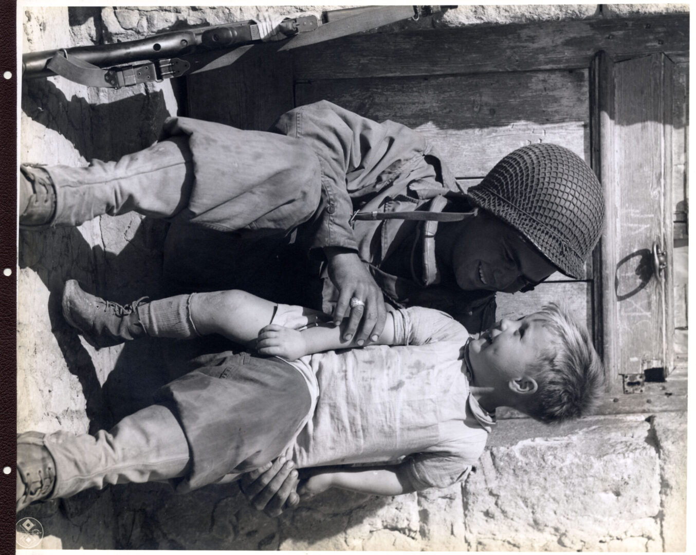 An American soldier bonds with a young French boy