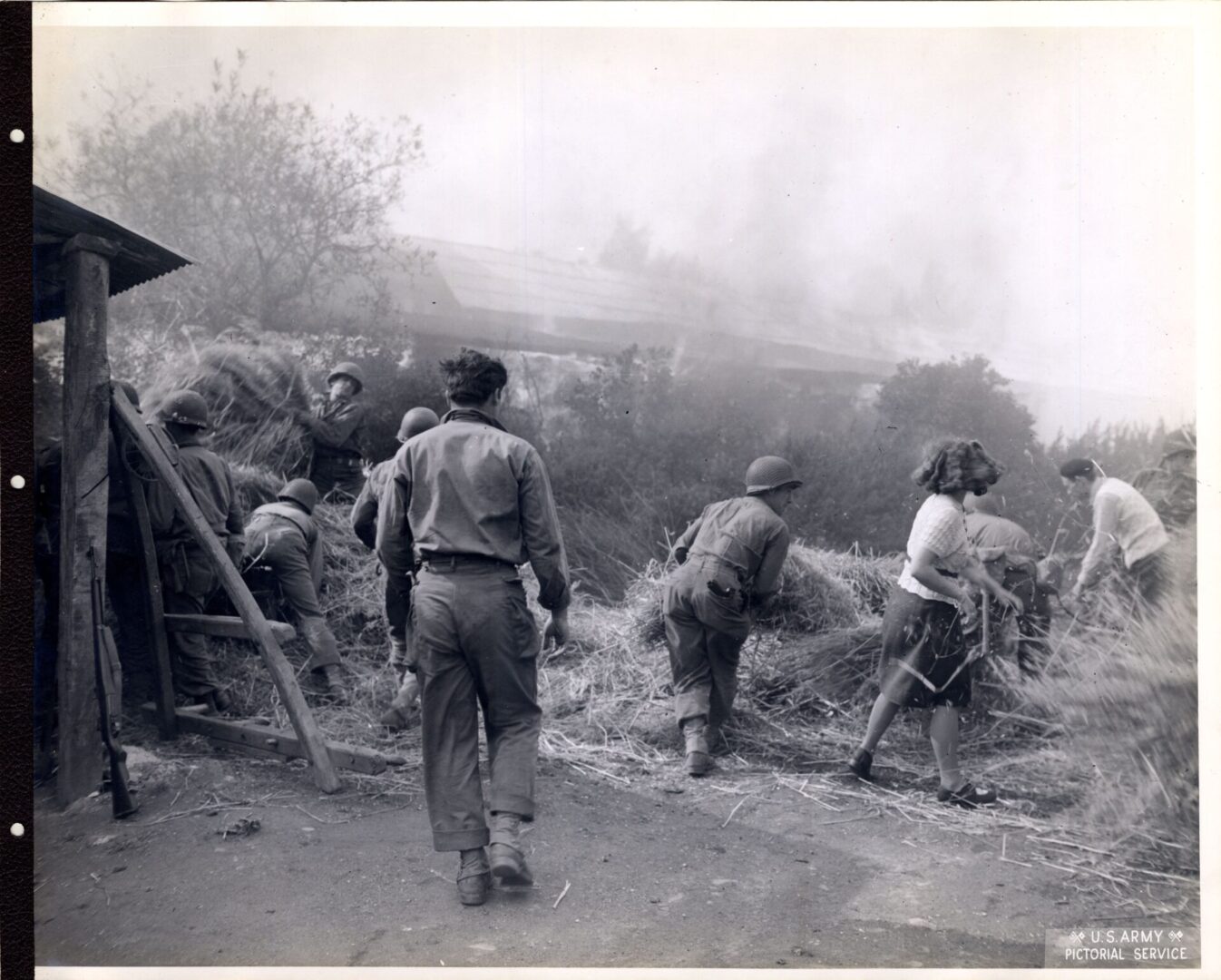 American soldiers helping French girl douse a fire