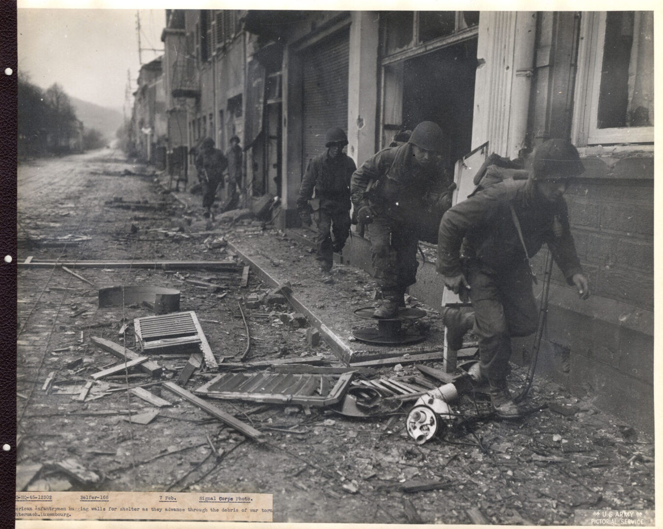 Infantrymen move cautiously taking cover of buildings