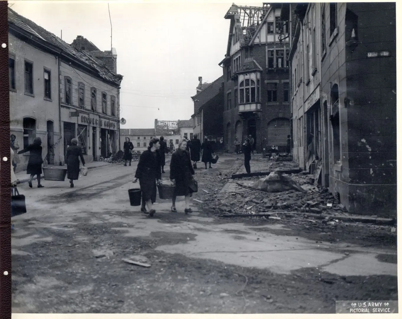 American infantrymen advance through a destroyed town