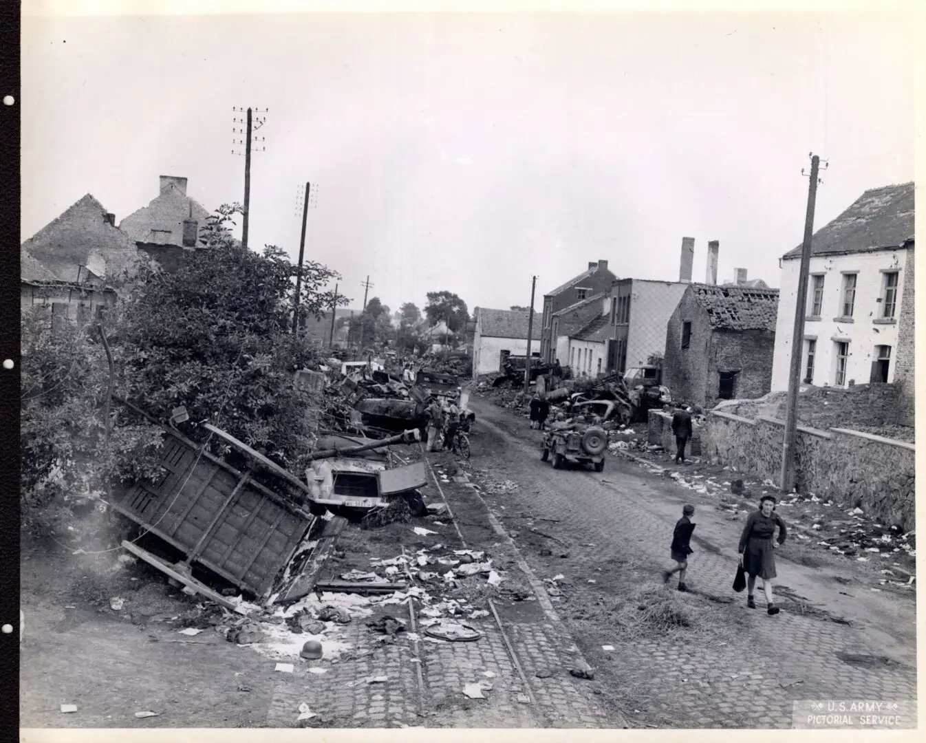Wrecked German vehicles being removed from the streets