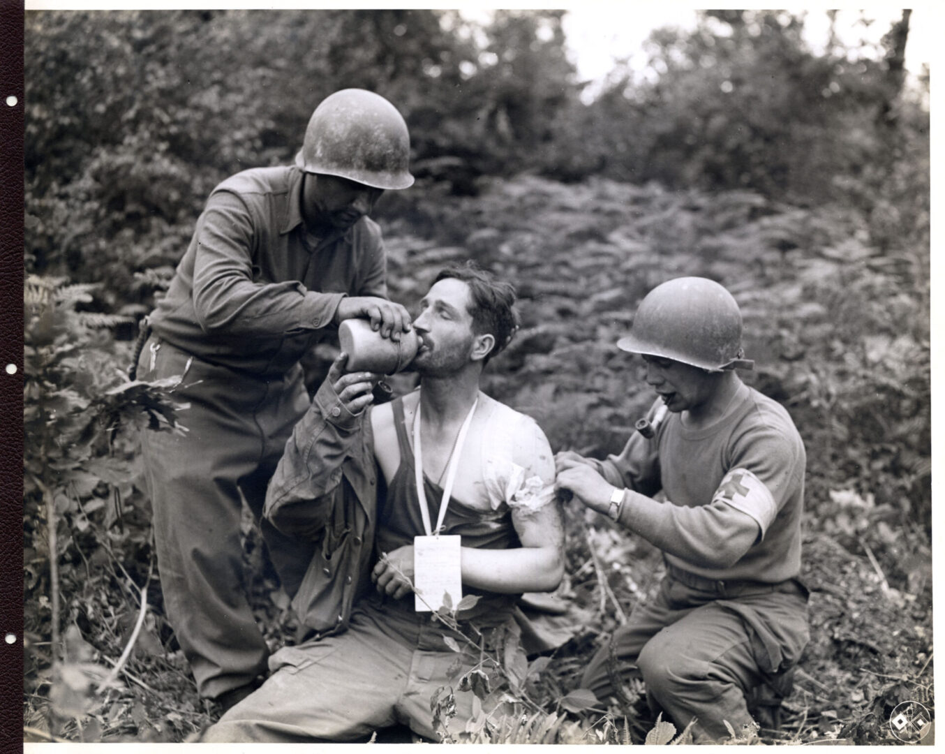 Medics provide first aid to a captured German soldier