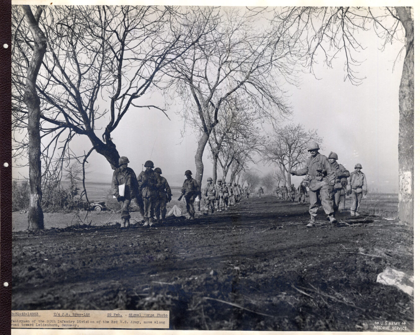 Infantrymen move along a road in Germany