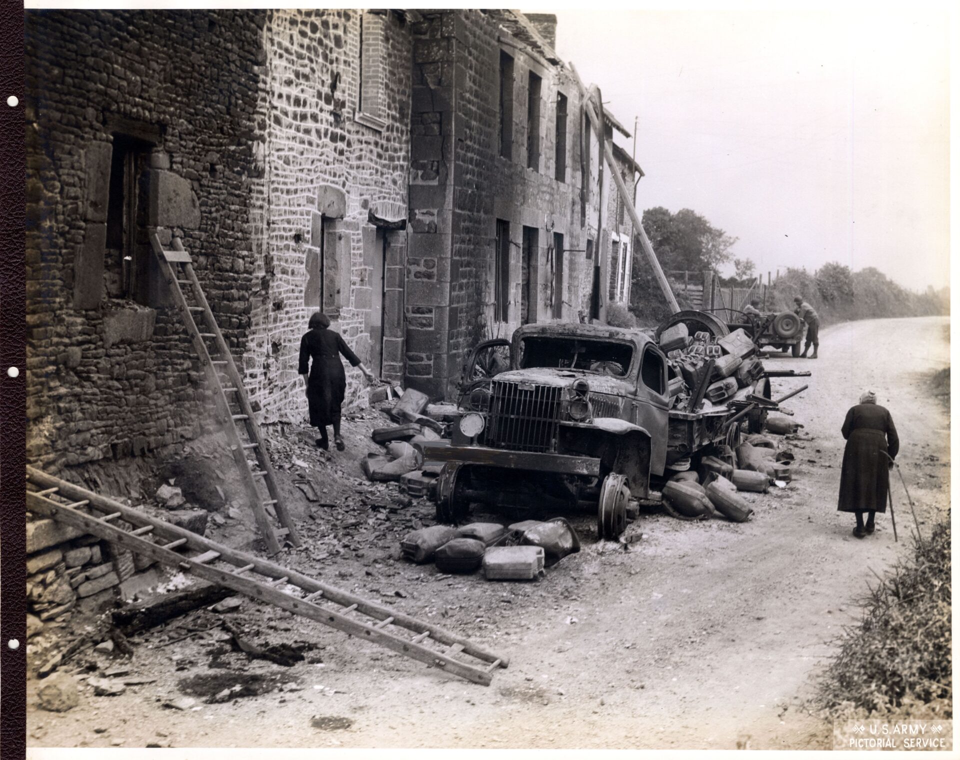 French citizens watch American troops passing their town