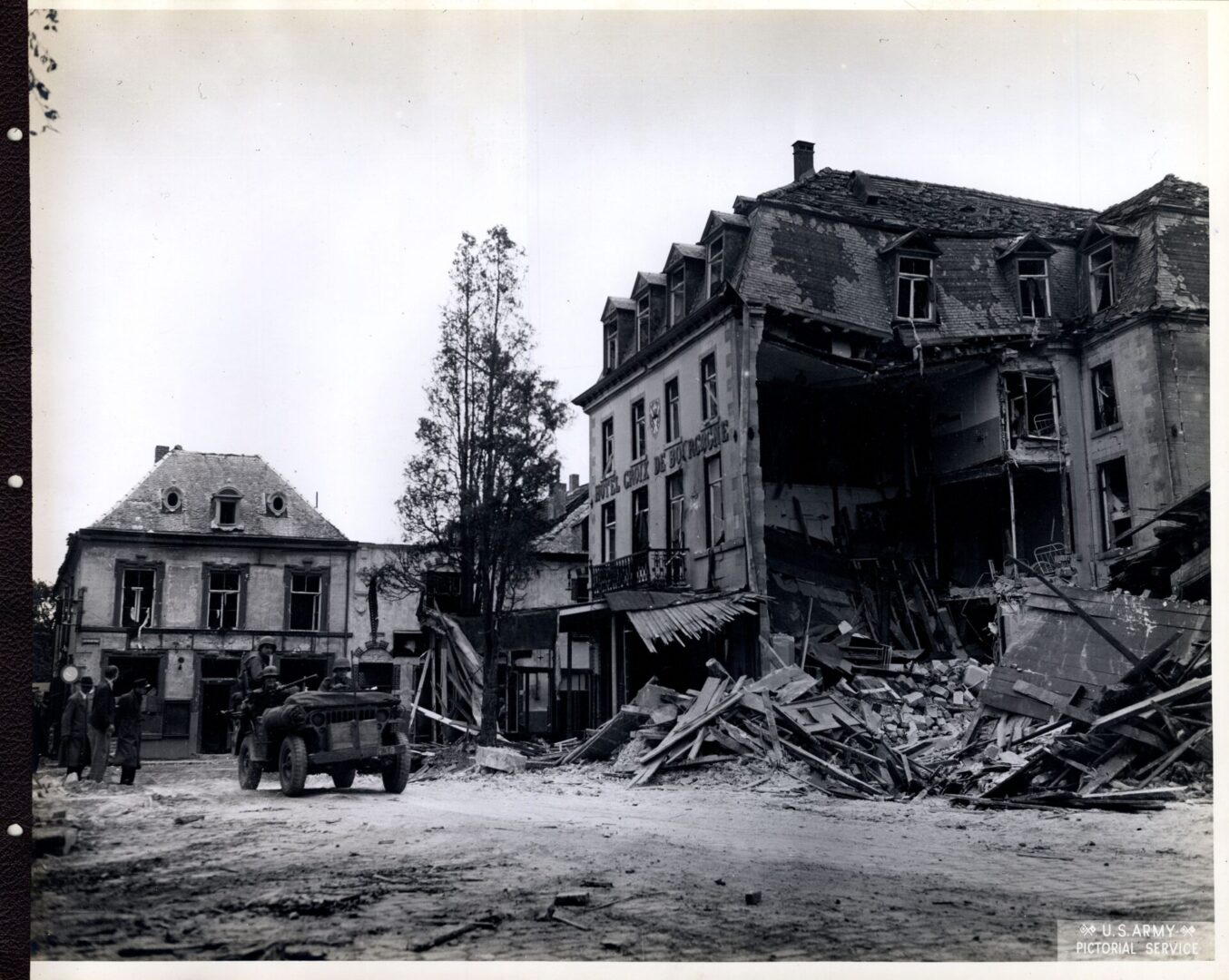 Jeep passing through wrecked town of Vallenburg in Holland