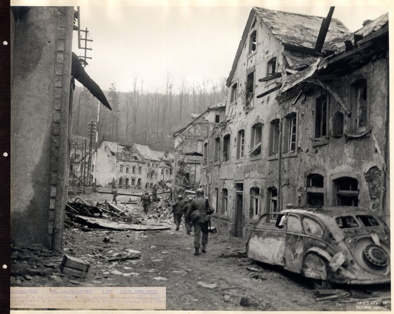 Infantrymen patrol the littered streets of Prum in Germany
