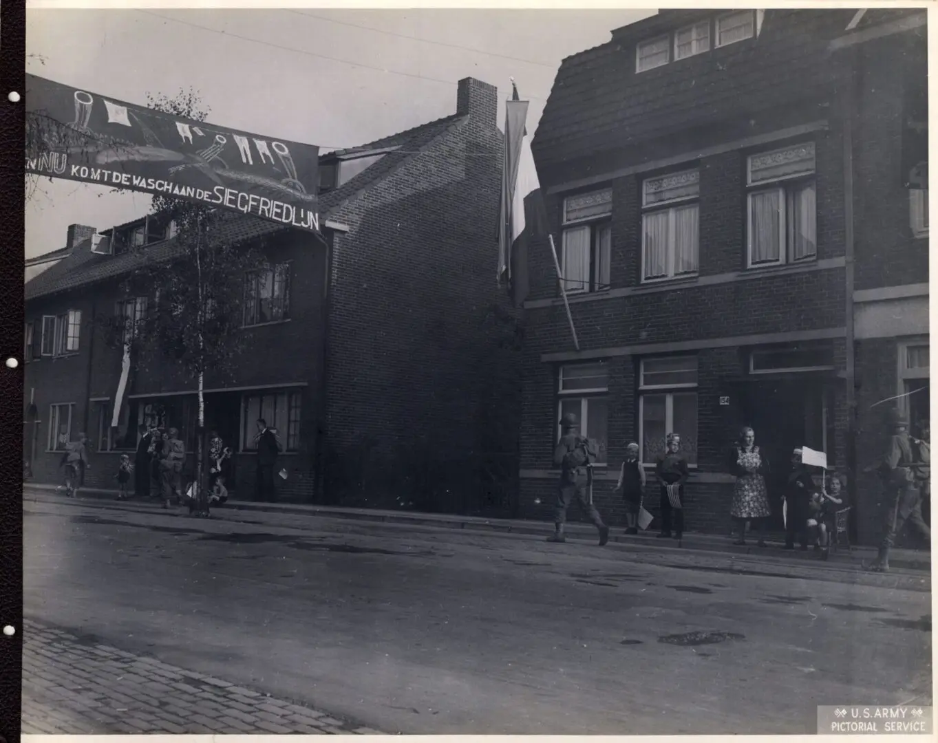 American infantry passing by the streets in a Dutch town