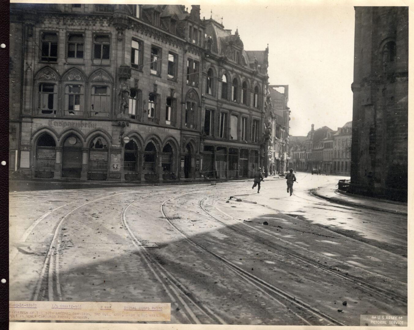 Infantrymen dash forward in the streets of Trier, Germany