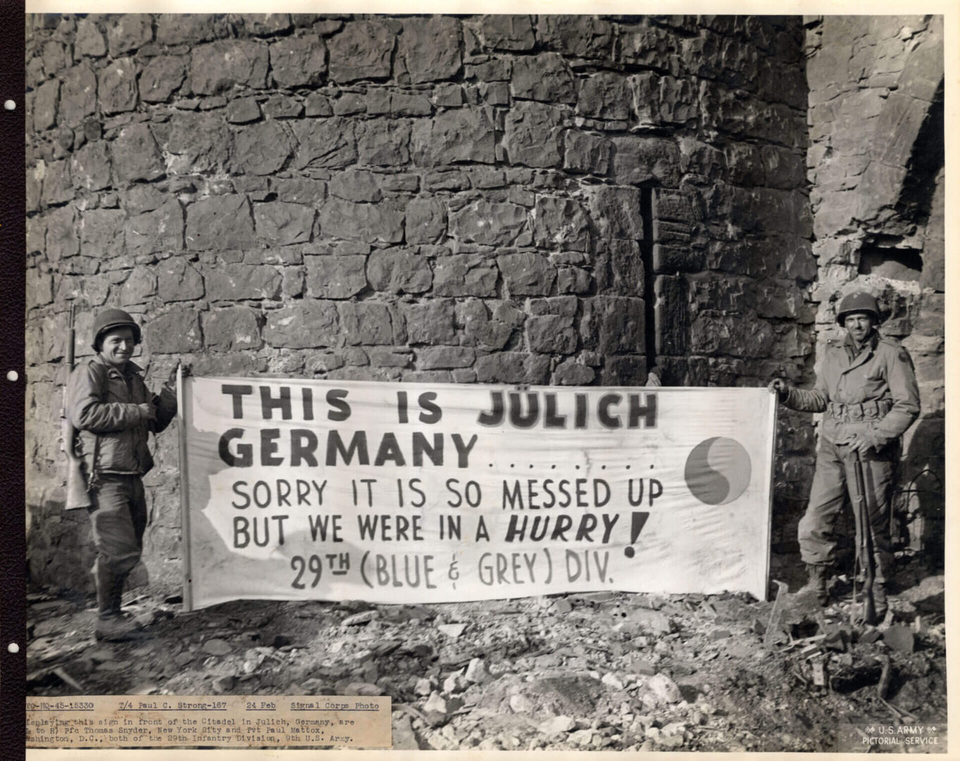 Two soldiers holding up a banner